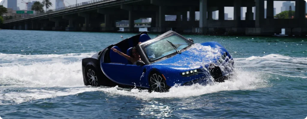 Blue luxury watersports car, four seat, speed boat, riding the waves. Series B with a lady enjoying the ride. Available at Pier One Yacht Sales
